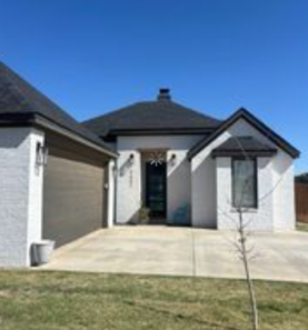 White brick home with new shingle roof